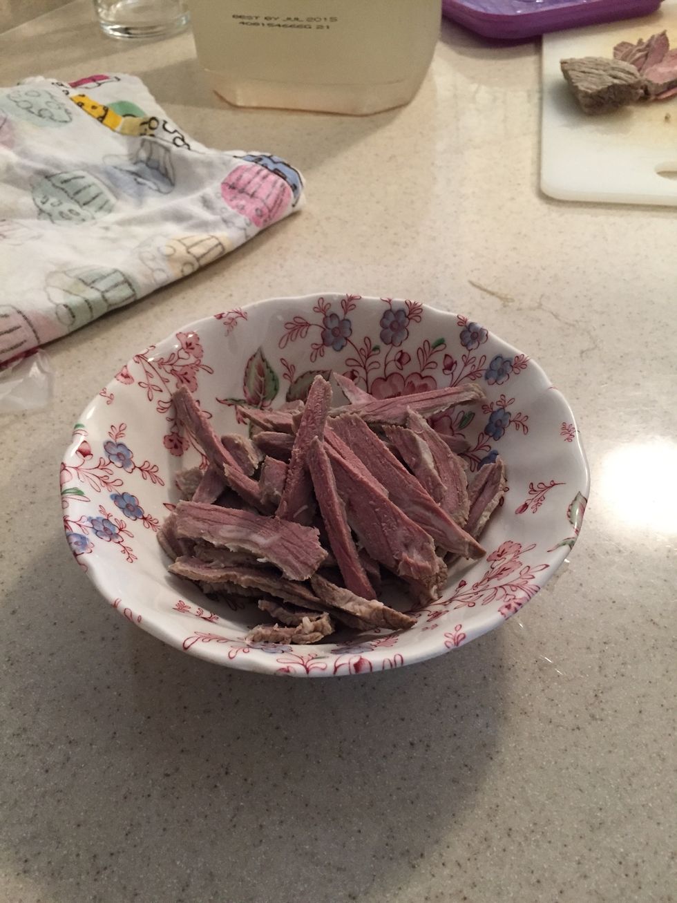 Boil beef in water for 20 minutes, then let cool. Remove fat, thin slice beef