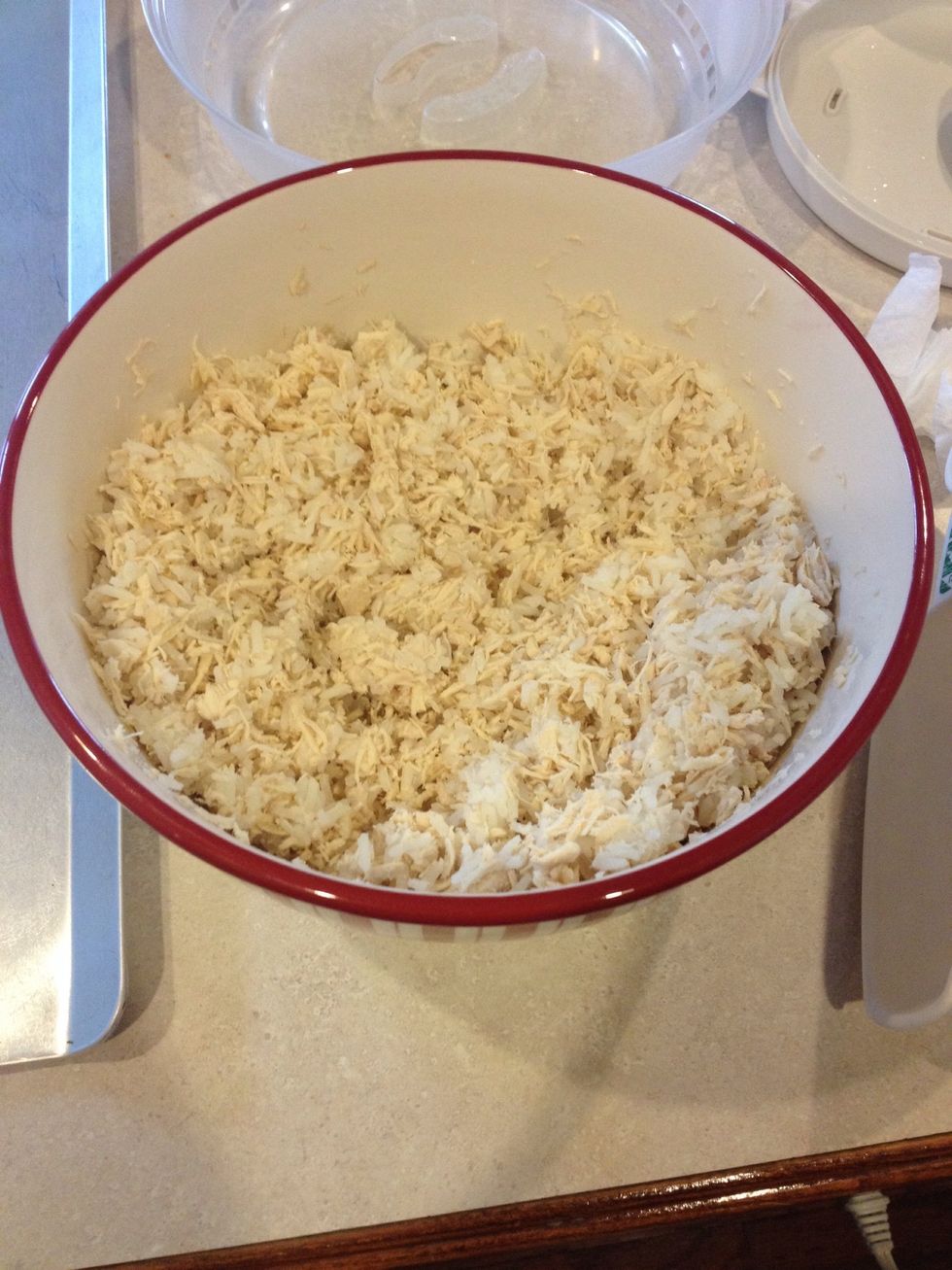 Boil chicken breasts & shread with food processor. Cook rice. Combine shredded chicken & rice ( should be about 50/50 mix)