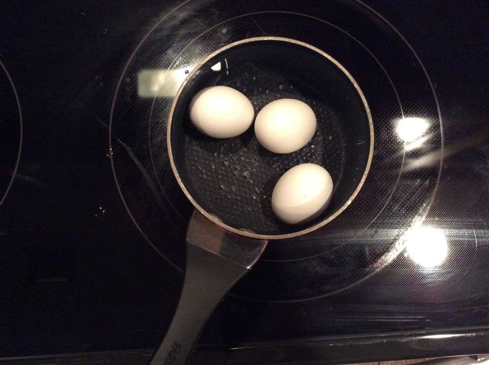 Boil eggs in a pot of boiling water