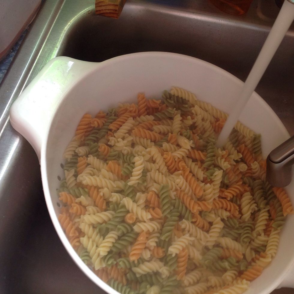 Boil multi color rotini for 7 minutes and drain, rinsing with cold water.