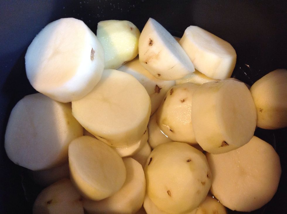 Boil potatoes in water until soft.
