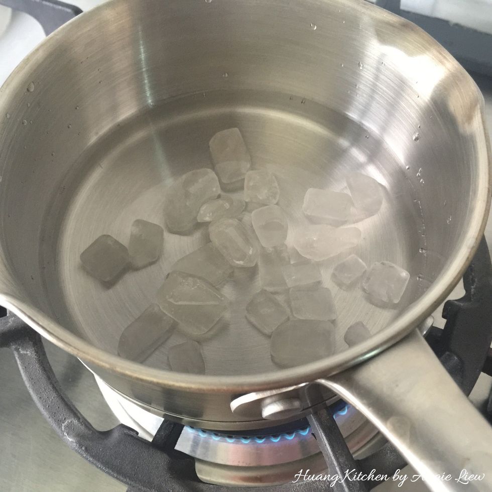 Boil rock sugar and water on low heat until the sugar dissolved, stirring occasionally.
