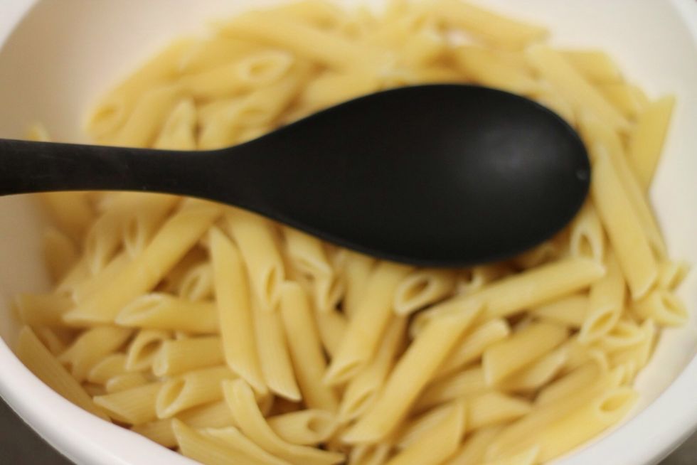 Boil salted water in a large pot and let the pasta cook for a little while. Do not let it cook completely as it will continue cooking in the oven. Drain the pasta.