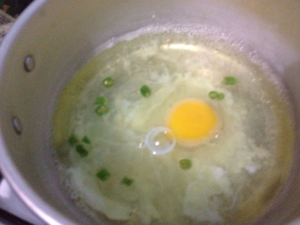 Boil some water (not as much as the amount of water for noodle-cooking process).   Add in the finely chopped small green chilis and poach your egg at the same time. However,  fried egg is also OK