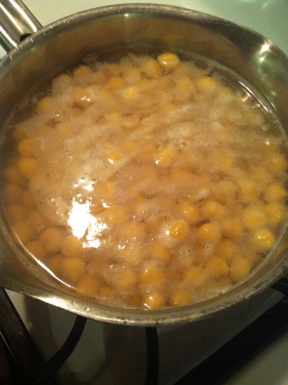 Boil the beans in a pot to soften them up.