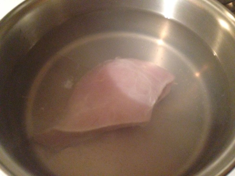 Boil the chicken breast so that it is fully cooked. Then remove the chicken from the boiling water and let it cool.