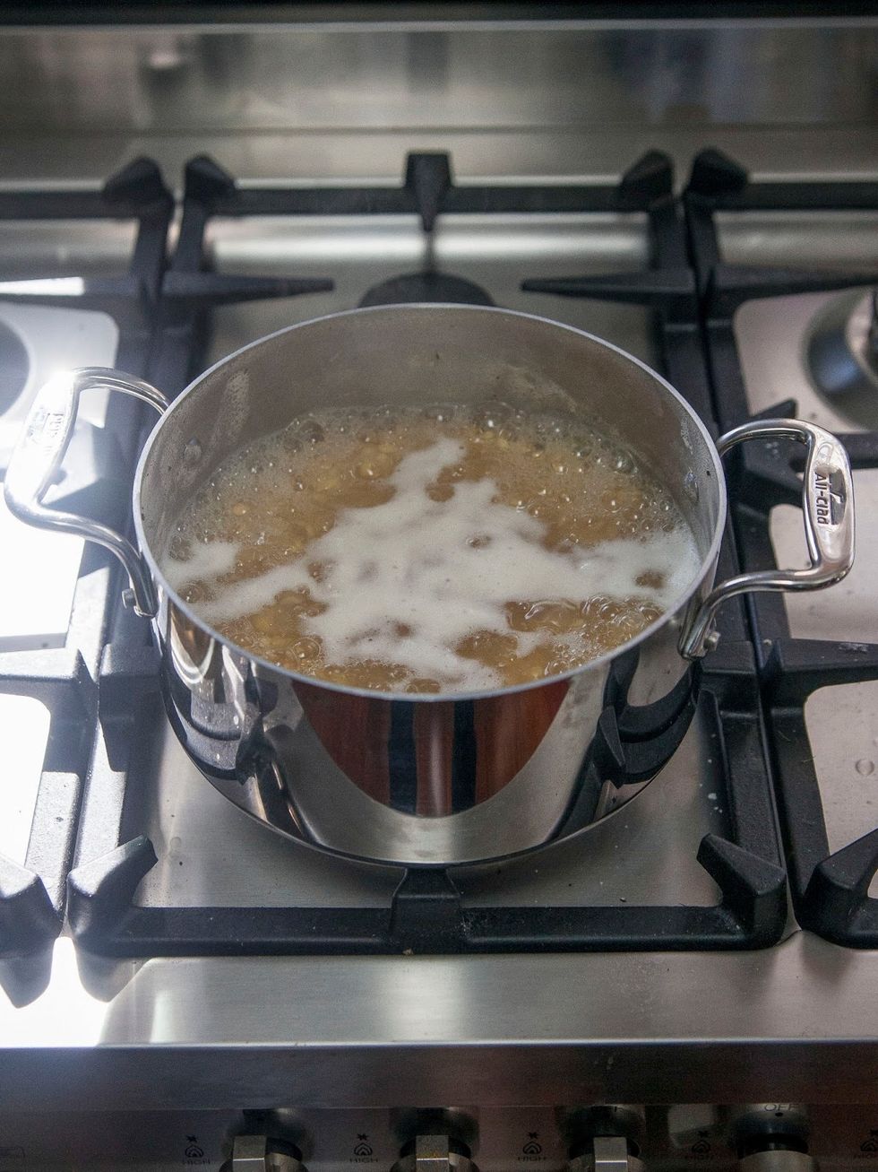 Boil the dal until it's tender. Skim off any scum that may rise to the surface.