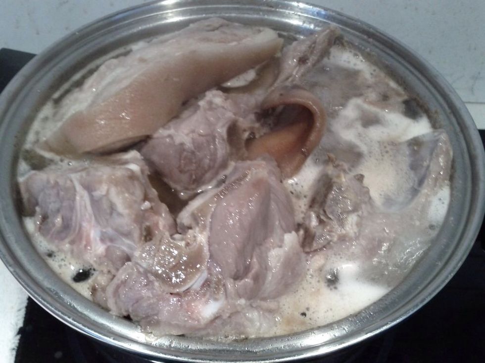 Boil the meat and pork in a double boiler pot of water. Add a couple of Oxo beef cubes. Then simmer until tender. Keep the stock.