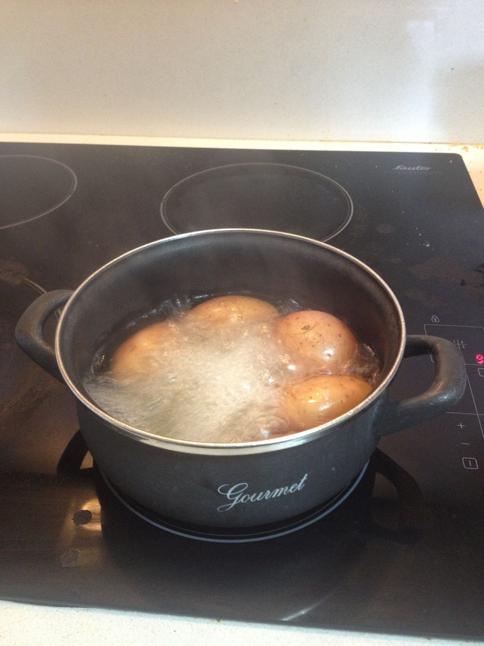 Boil the potatoes until they are soft when you stick them with a fork/knife/toothpick