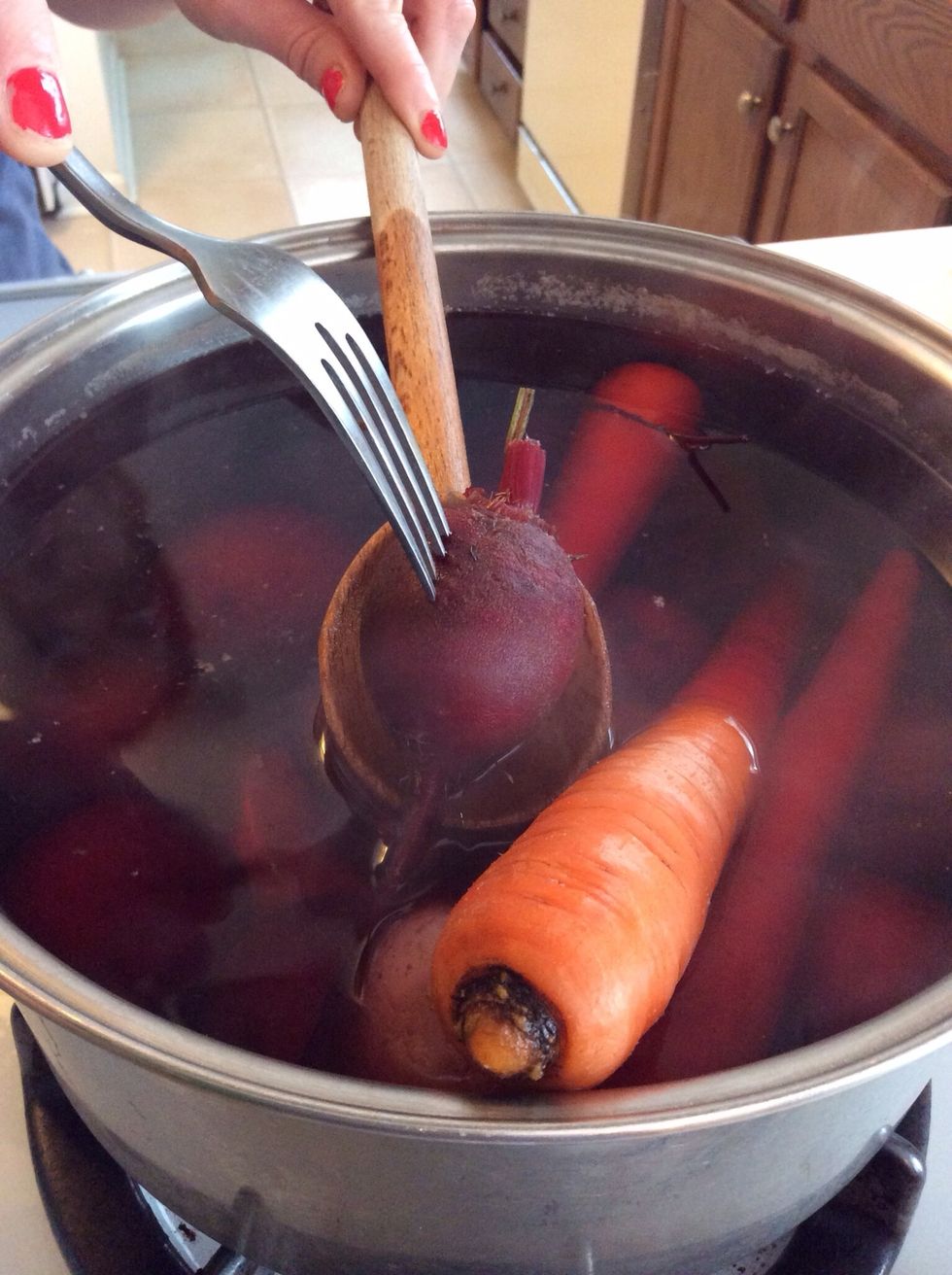 Boil the veg for about 20 minutes, then check for doneness with a fork. If you can pierce easily it's done. The beets may take a little longer than the taters and carrots.