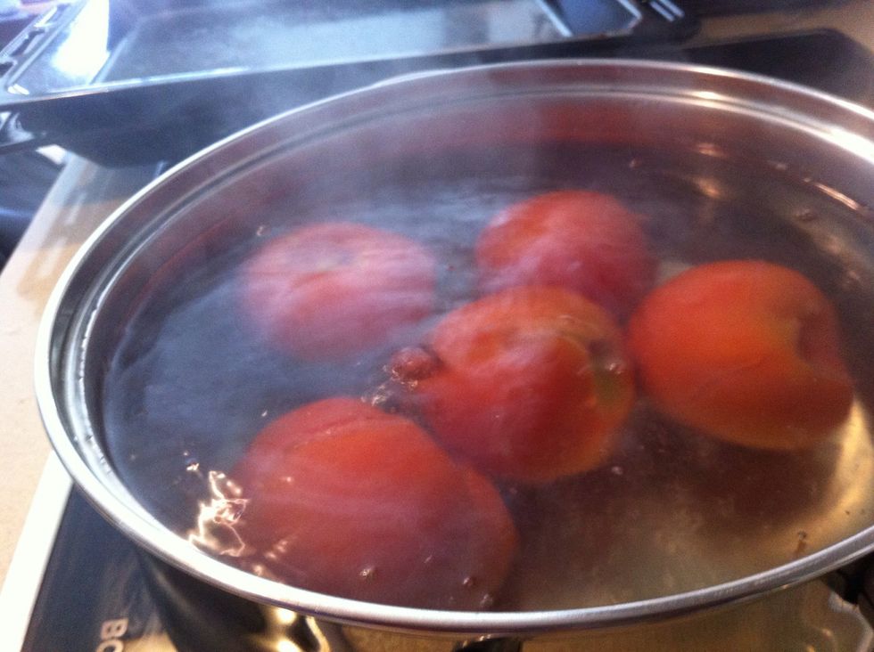 Boil the water and put tomatoes inside for 20 seconds only