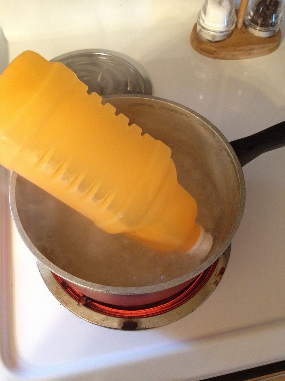 Boil the water, and then put the bottle in the water for about a minute. The bottle will start to expand.