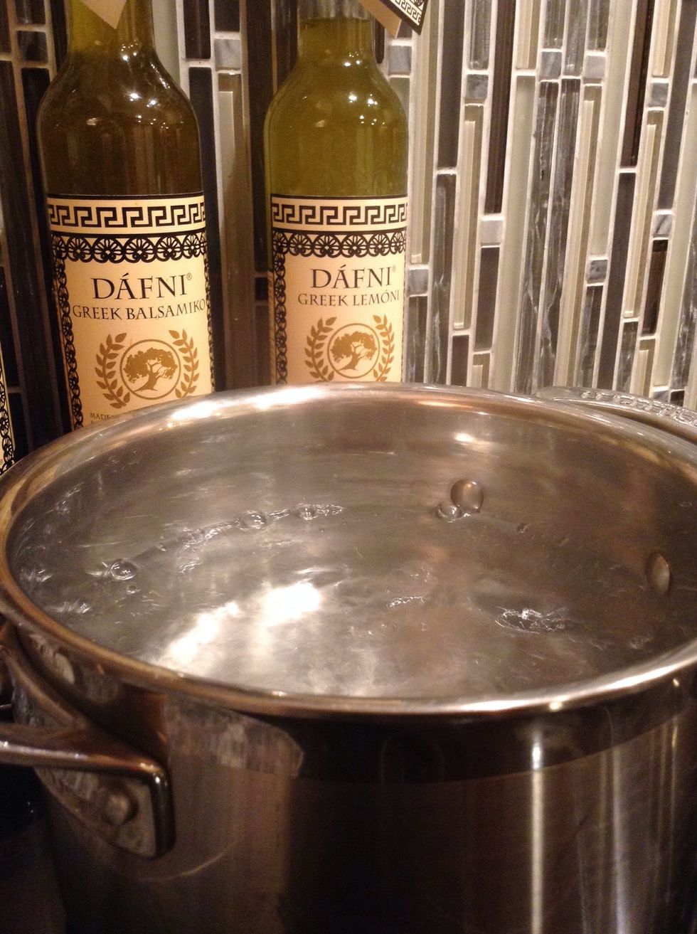 Boil the water over high heat. Once it's at a rolling boil, turn the heat down a little. It should still be boiling, put not as intense.