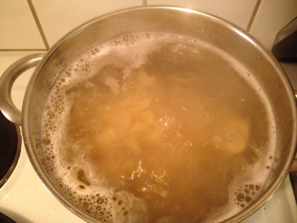 Boil water and add the pasta. Add some olive oil as well.