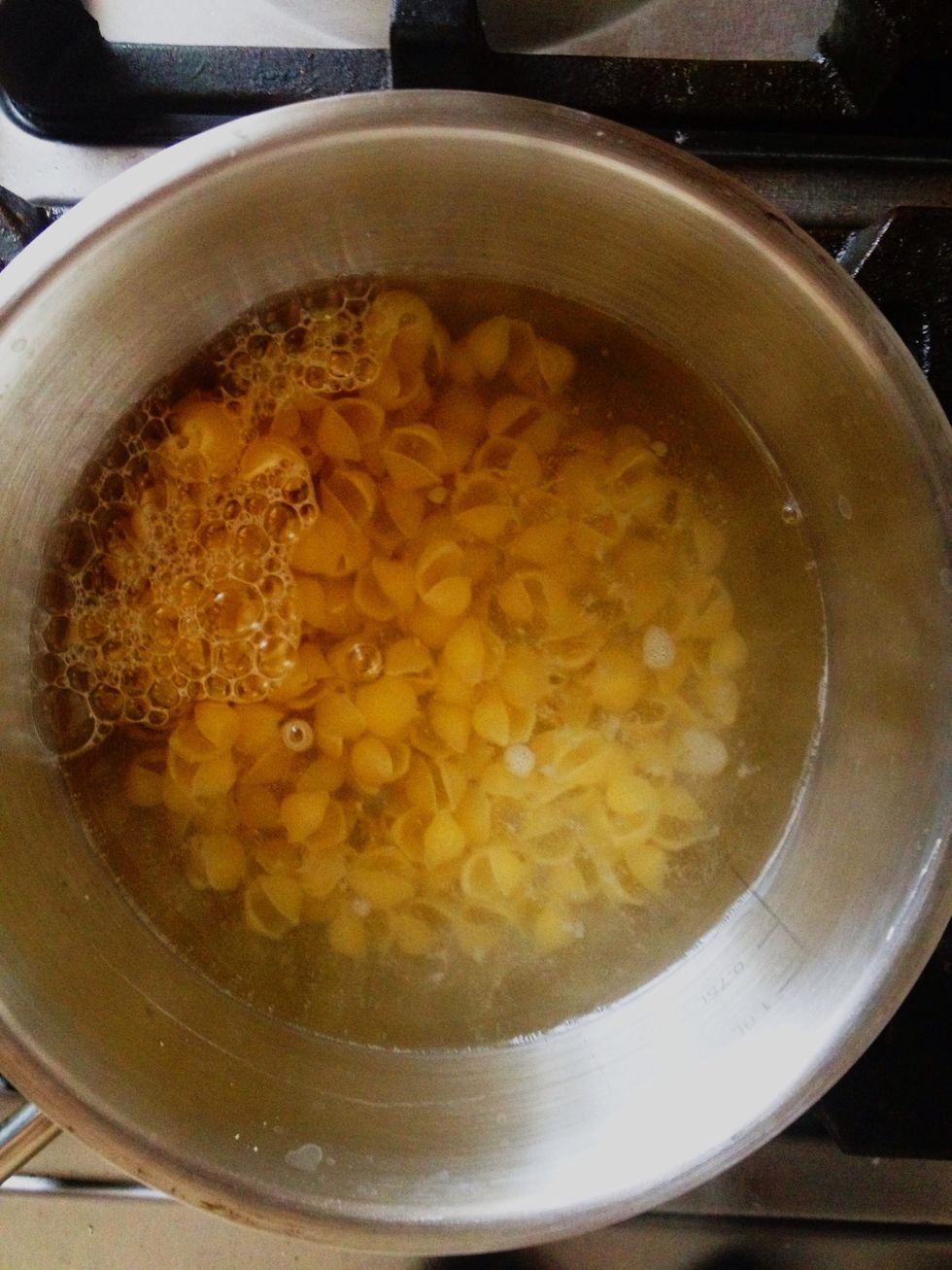 Boil water and cook macaroni according to the package instructions.