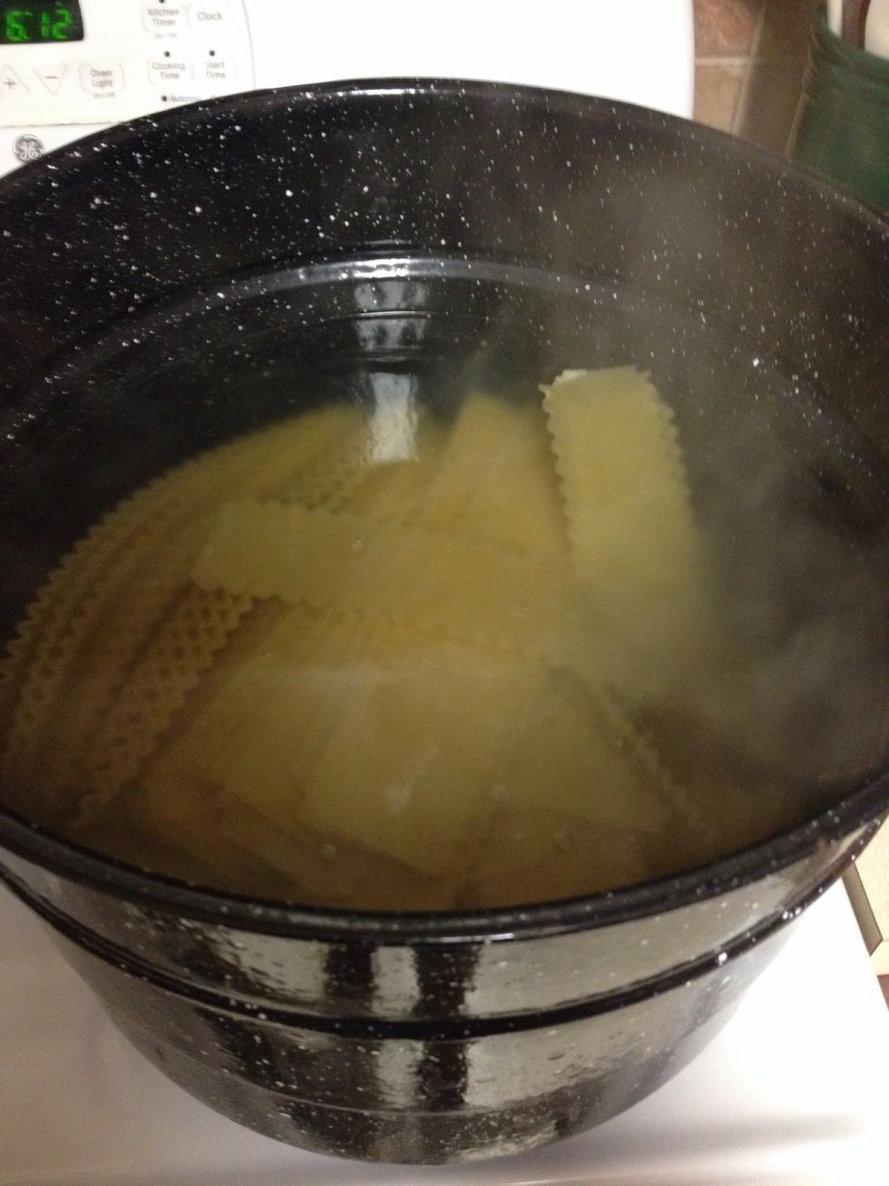 Boil water and then carefully place lasagna noodles into the pot while stirring to keep the pasta from sticking