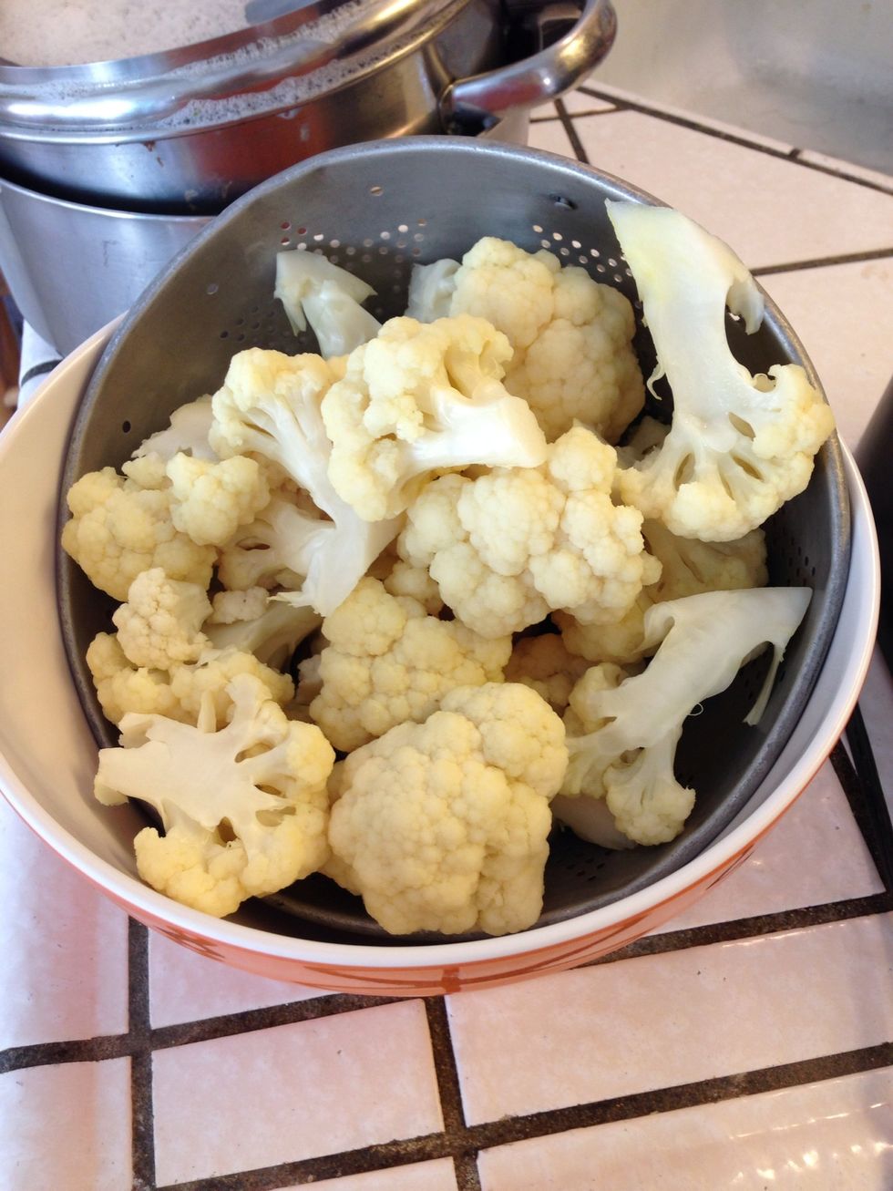 Boil water then add 1 tsp cumin and chopped cauliflower for one minute. Then rinse the cauliflower in cold water and drain. Let sit until dry