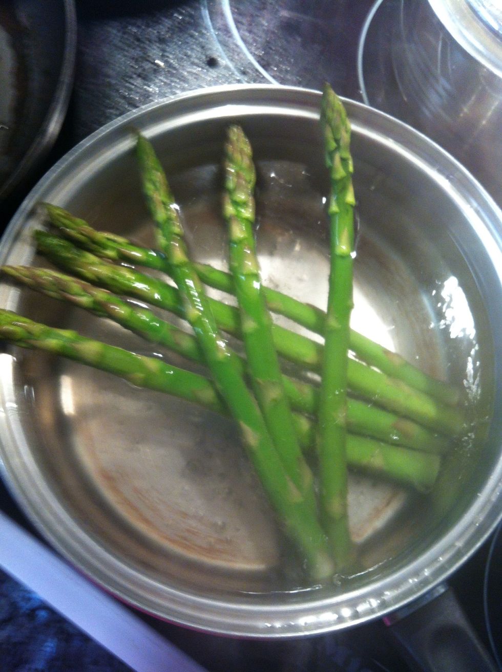 Boil water then add esparagus cook for 3-5 minutes