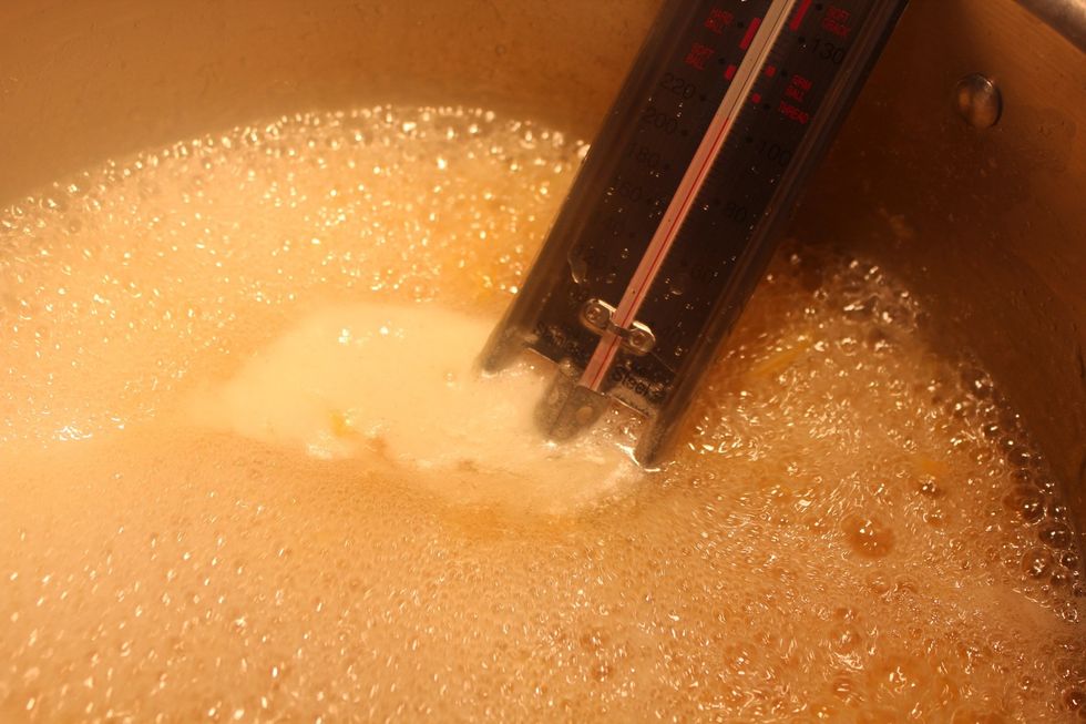Boil your marmalade until the candy thermometer reads 222. Take care that it doesn't boil over, and stir often so that you don't scorch the bottom.