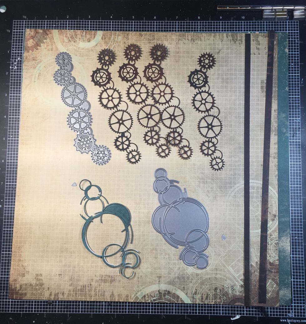 Both of these dies are from my stash. They are Memory Box dies. I used some of the dark brown paper for the gears, and the darker teal for the distressed circles.