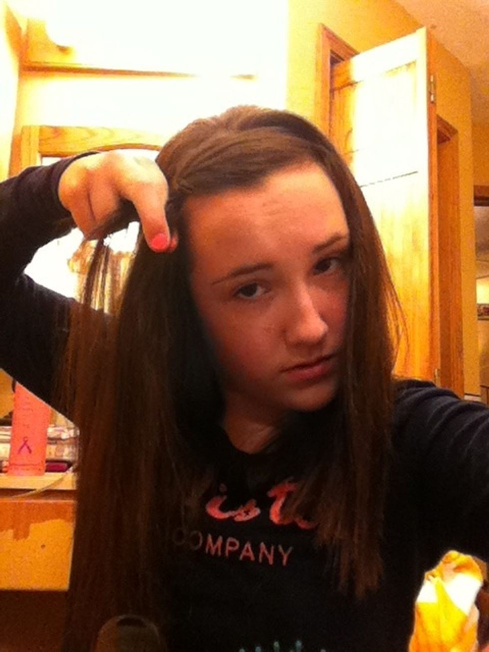 Braid regularly 3 times and then grab a section of hair and add it into the nearest strand of hair