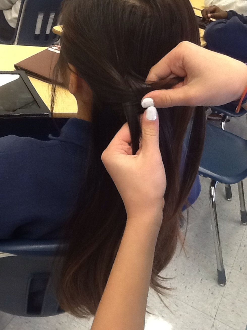 Braid the piece of hair that you took just a little bit. Not all the way.