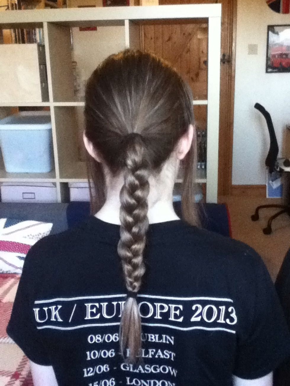 Braid the ponytail and secure with a hair tie.