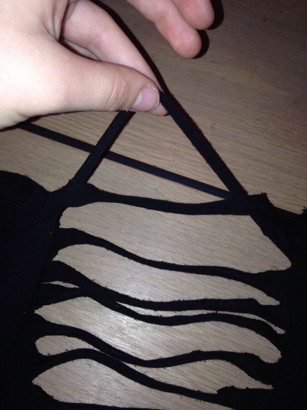 Braid the strings. Start by pulling the second string under the first string and create a loop. Pull the next string trough the loop. Continue like this.