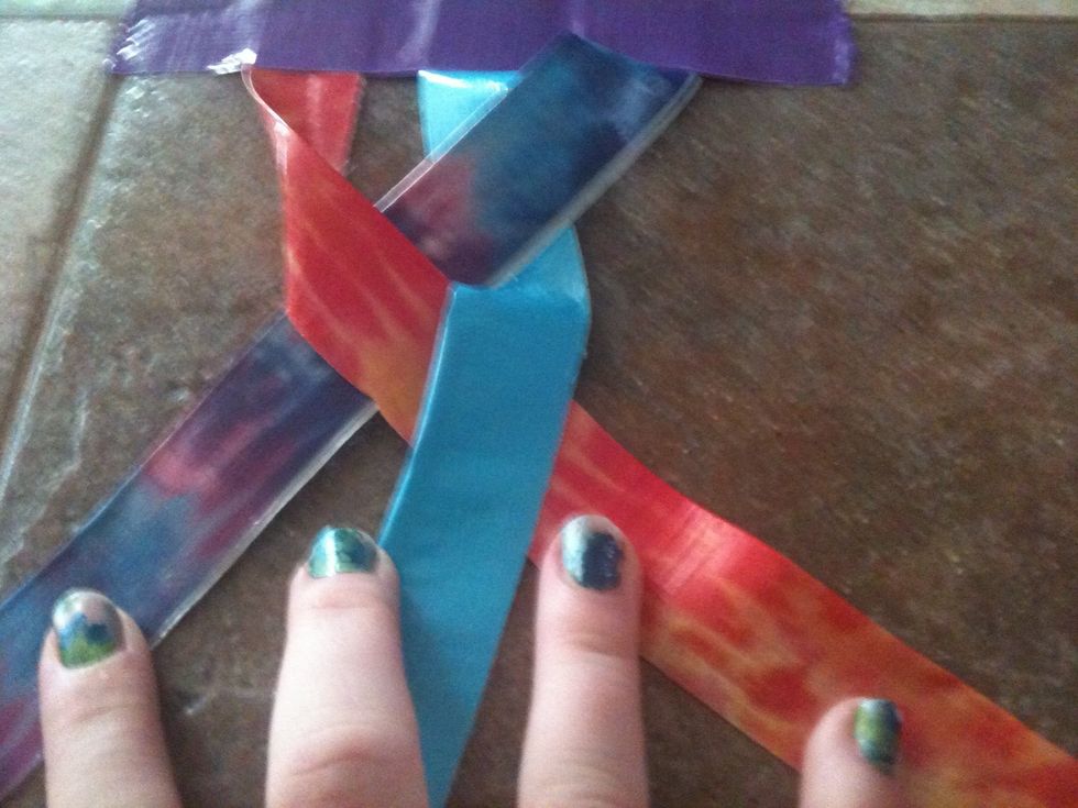 Braid the three strips. Start loosely at the beginning and once you have braided four or so stitches you should start braiding tighter.To make your braid tighter braid another stitch and then pull up.