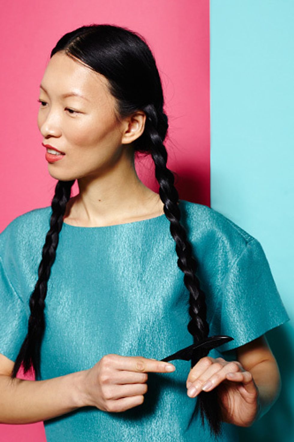 Braid your hair into two braids. Rather than using an elastic at the bottom, give the ends a quick backcomb so they stay in place. Finish the braid where you want your curls to end.