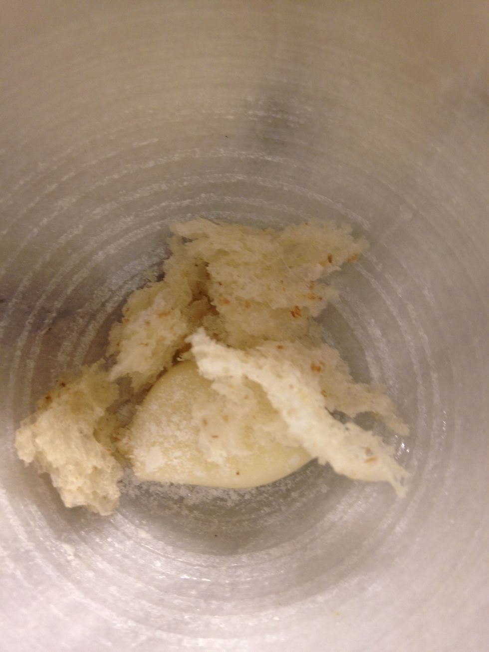 Bread. Soaked in milk or not. If you are using a yolk instead of bread add it after crushing the garlic