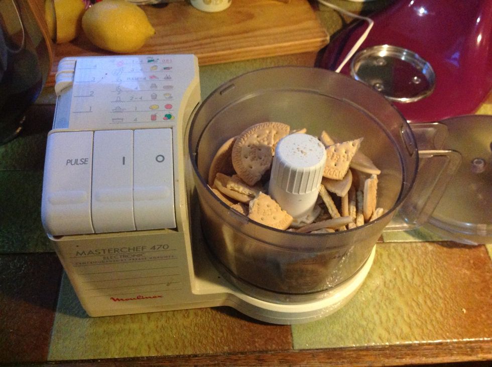 Break 150g biscuits into the food processor. (This makes it easier to blend) and then crush biscuits in food processor.