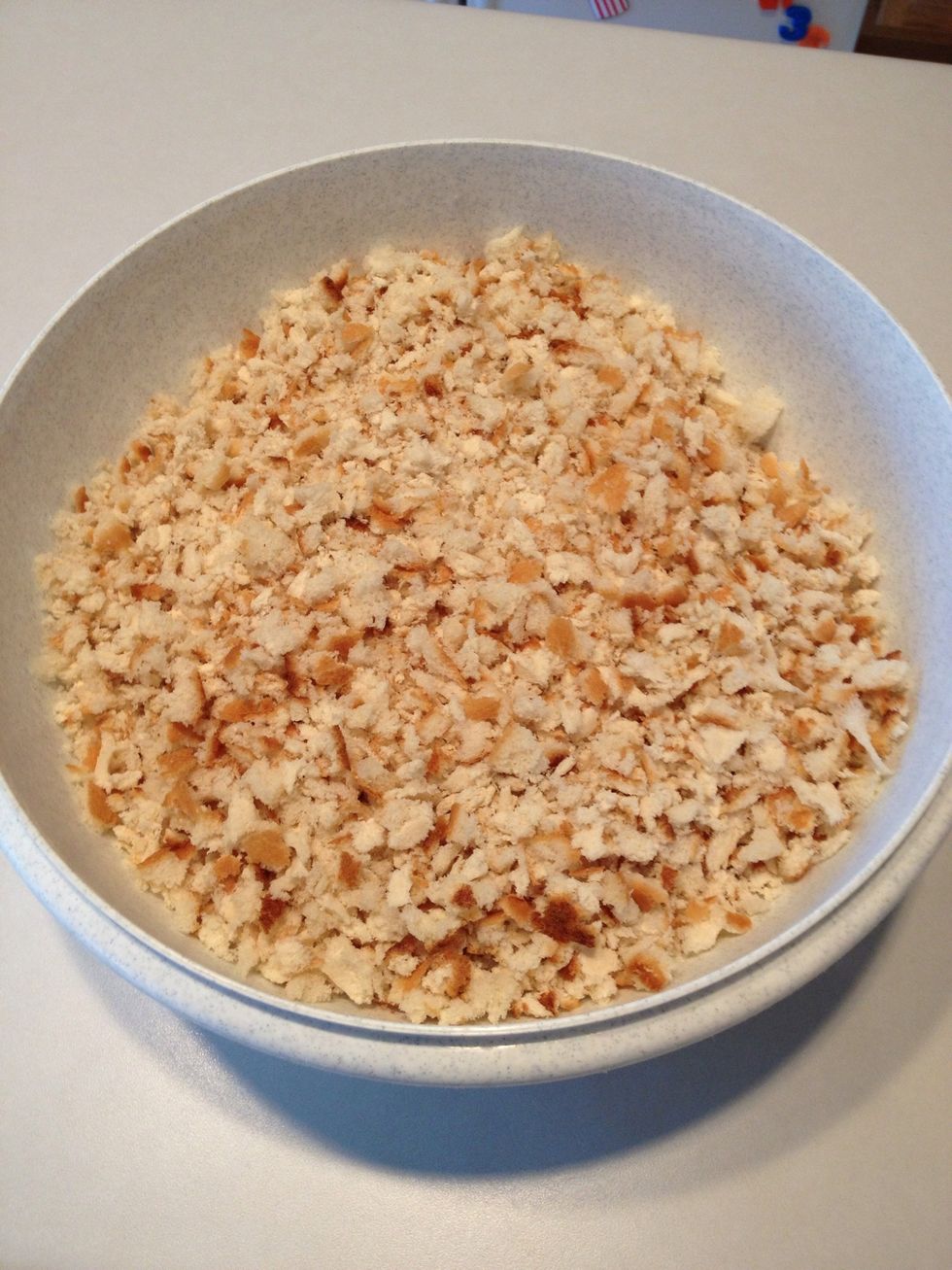 Break bread into small pieces in large bowl.