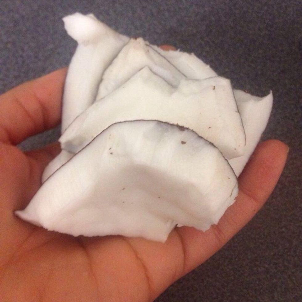 Break coconut shell and remove the hard jelly. Tip: the coconut shell is pretty hard so try to bash it initially on a hard surface then remove shell.