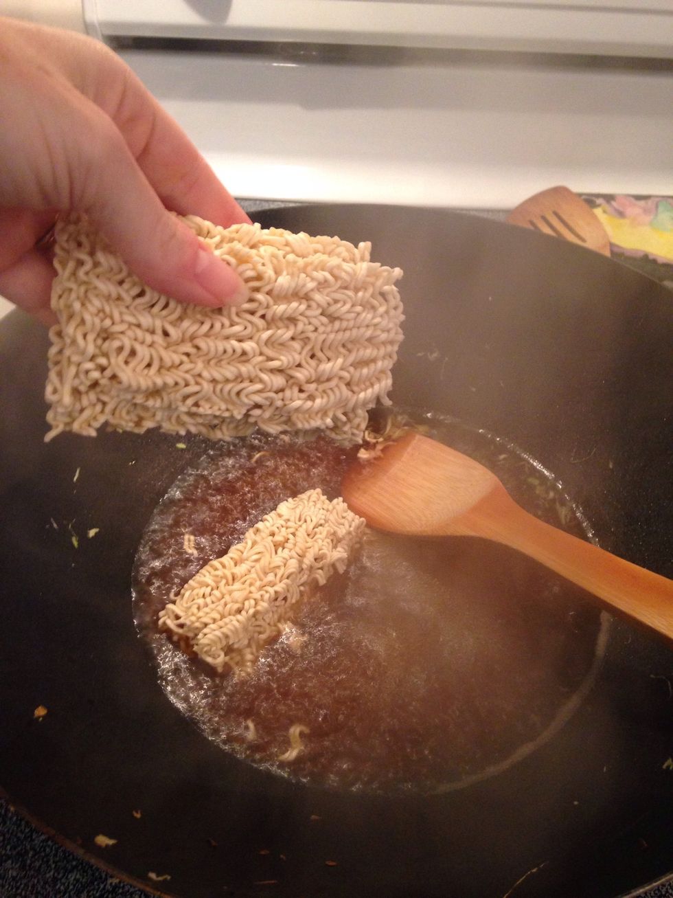Break ramen noodles in half and add to liquid. Cook for 2 minutes.