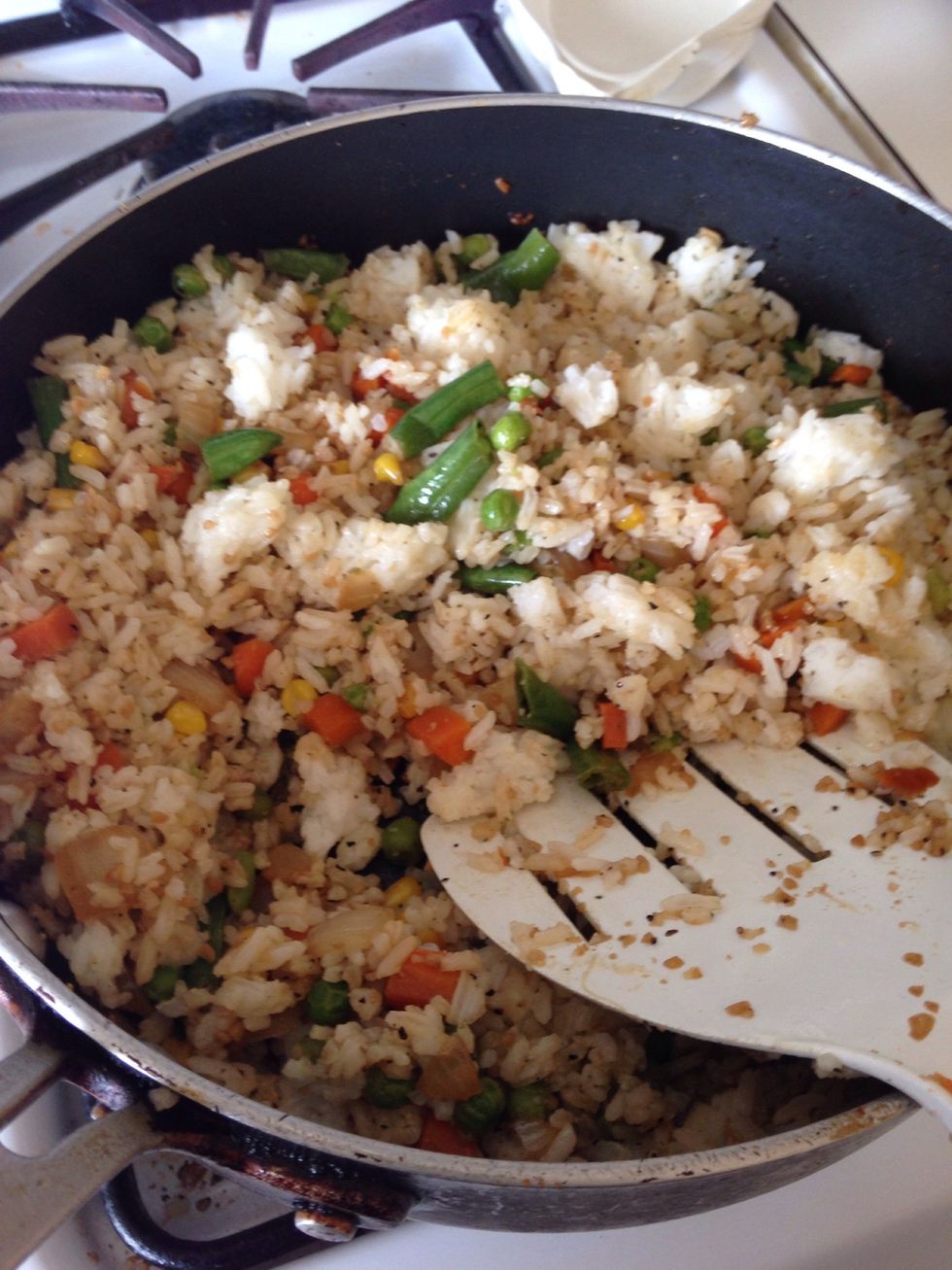 Break rice as you saut\u00e9 on medium high heat