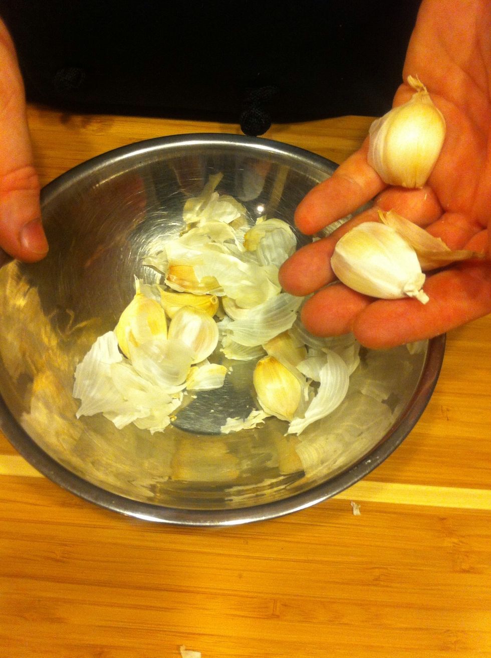 Break the head of garlic apart into individual cloves, and place them in one of the bowls.