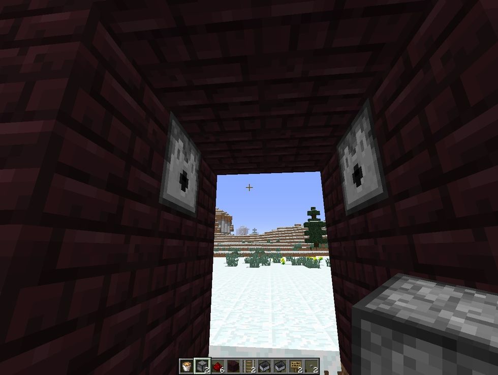 break the middle block of wall, and place dispenser facing out on both side