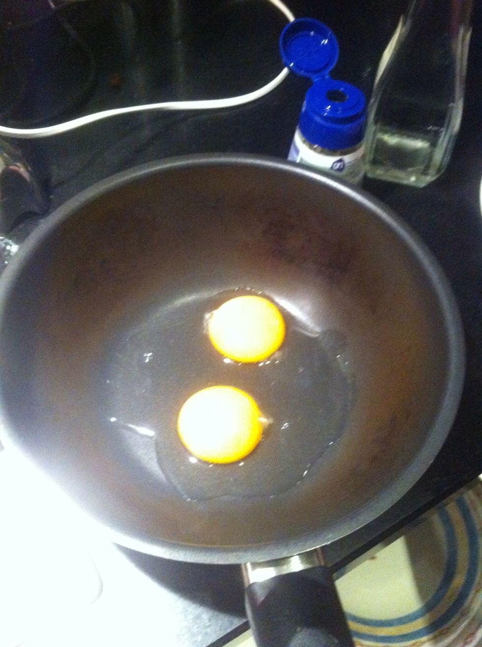 Break two eggs for the egg yoke in the frying pan. ( This is for 4 people or meals.)