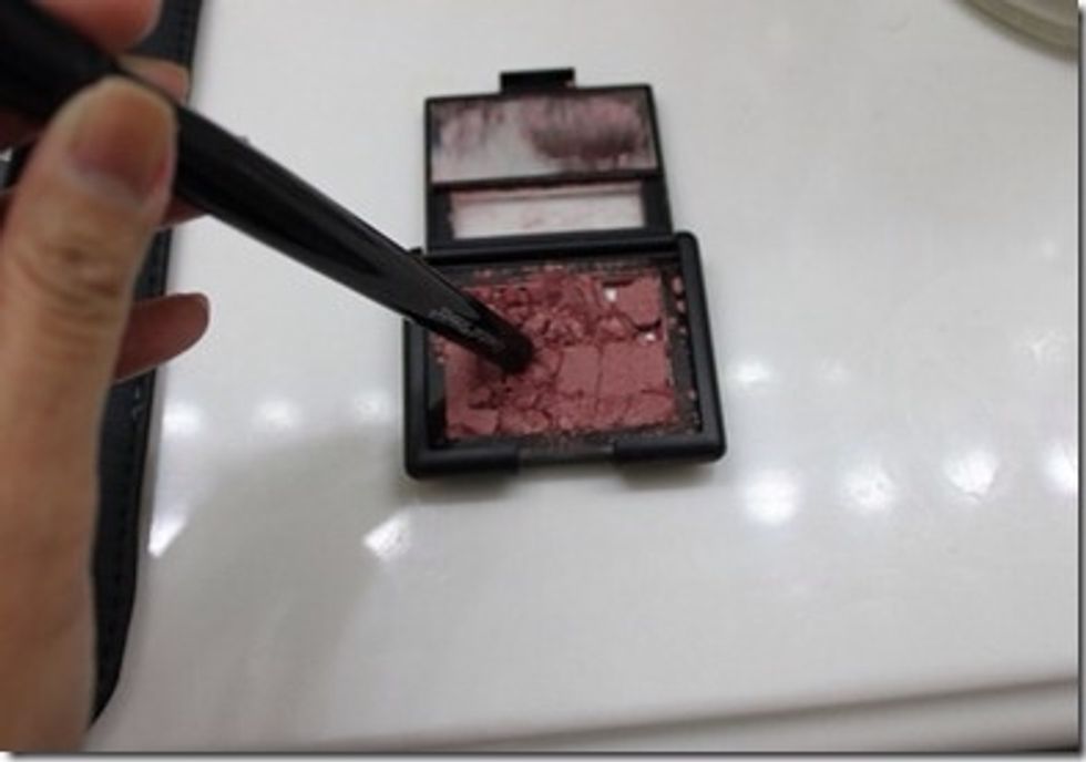 Break up any remaining pieces of blush with cuticle stick, metal instrument or make up brush.