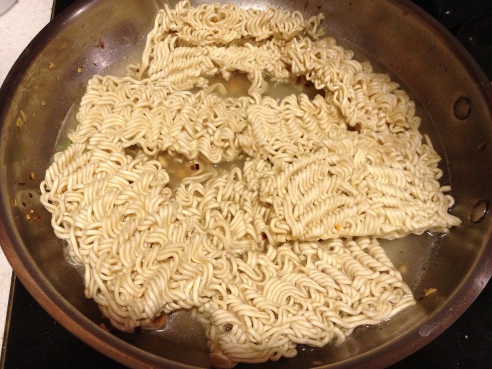 Break up ramen into manageable pieces and put in pan. Add 1 c. water (Keep some extra on the side in case it begins to dry out). Jack up the heat and bring it to boil.
