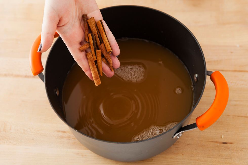 Break your cinnamon sticks into smaller pieces and them to the pot.