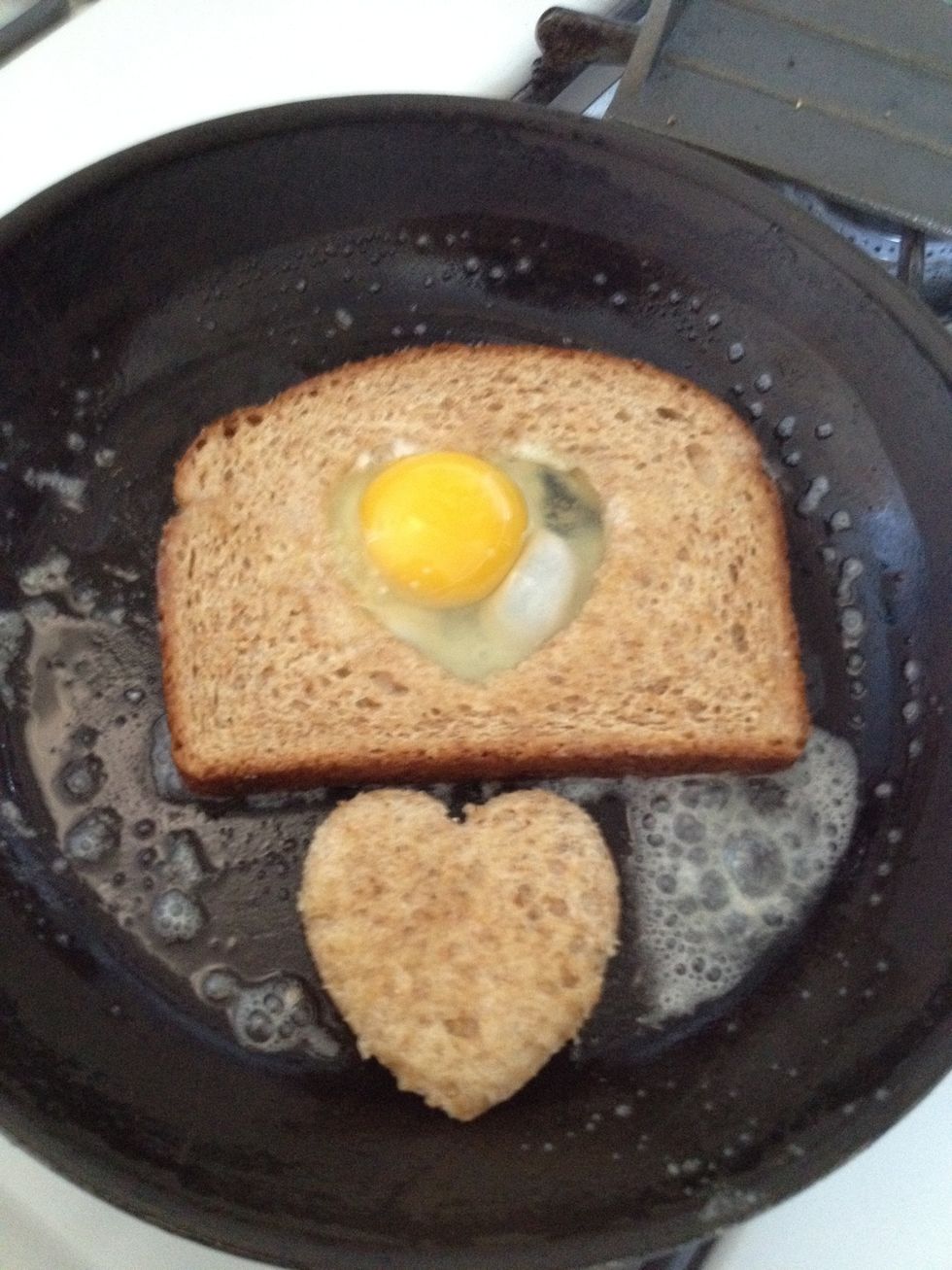 Break your egg in the heart \u2764 hole. Also cook the heart \u2764 bread in the pan too.