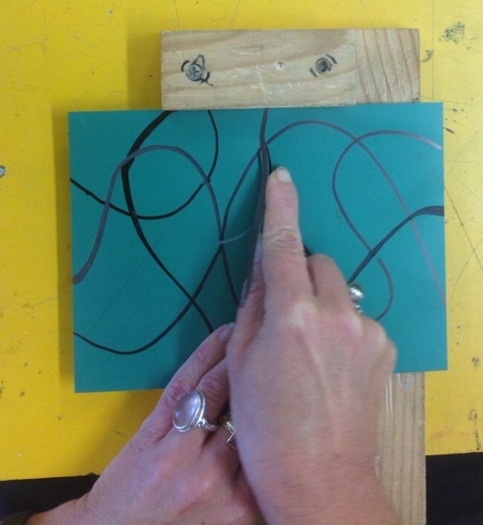 Breathe in, as you start at one edge breathe out guiding the tool with your fingers from one side of the Lino to the other. Alter your seating position rather than having the Lino off the guard.