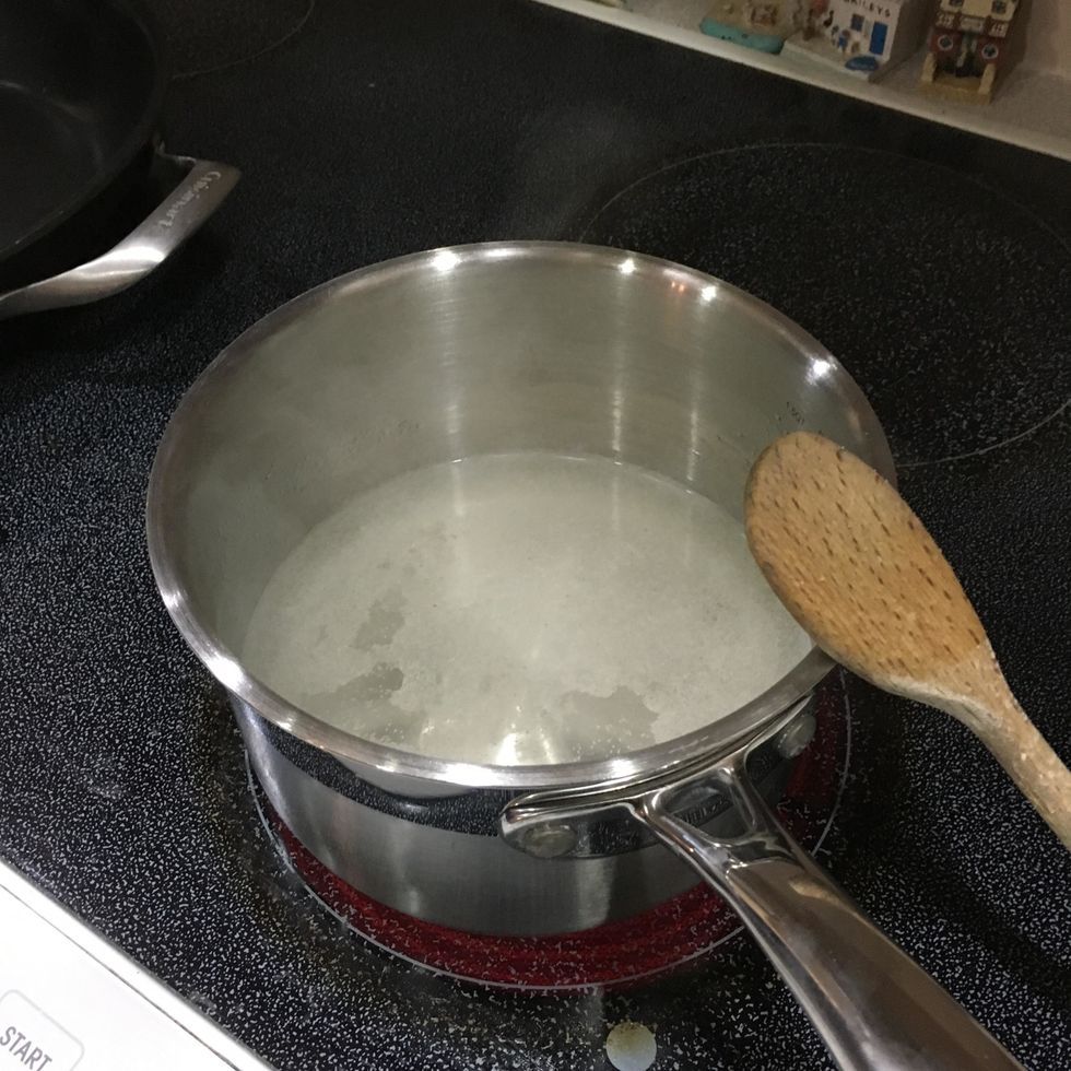 Bring 1 1/2 cups of water and garlic salt to a boil