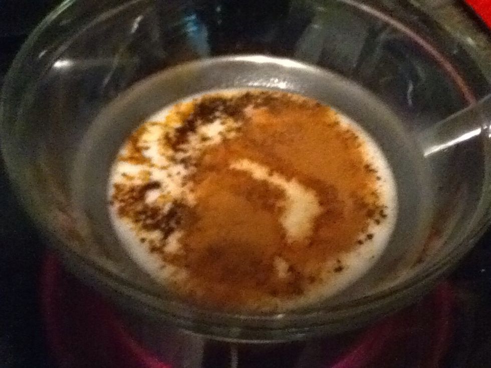 Bring 1/4 cup 'milk', instant coffee, cinnamon, 1/2 tsp vanilla, cayenne, and corn syrup to the barest of simmers in a double boiler, then remove from the heat and let it cool a minute.