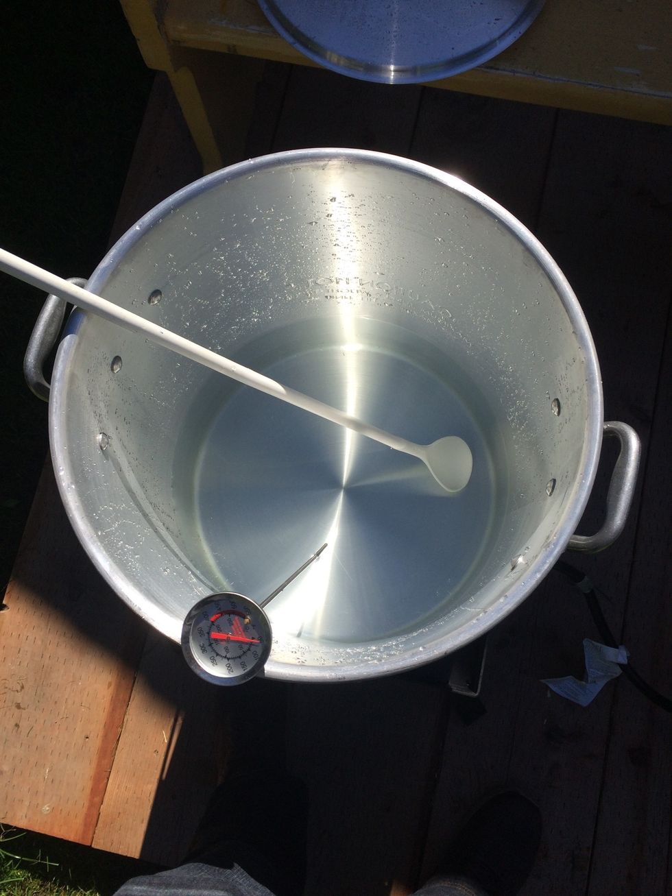 Bring 10qt (2.5 gallons) of water to 163.7 F on a propane burner. This is going to be your mash water.