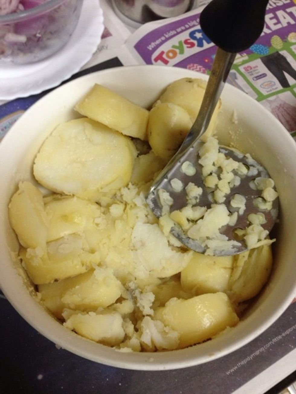 Bring 3 large white potatoes to boil in the microwave. Potatoes need to be in water and microwaved for 15 minutes. Cut them into pieces and after boiling, remove then skin and then mash.
