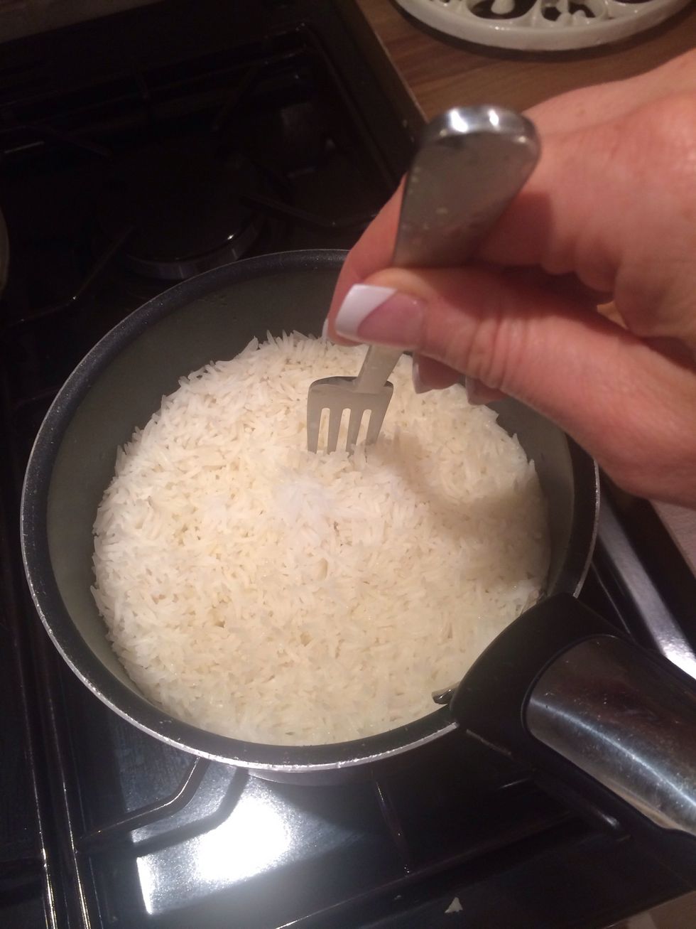Bring a fork gently through rice to fluff up