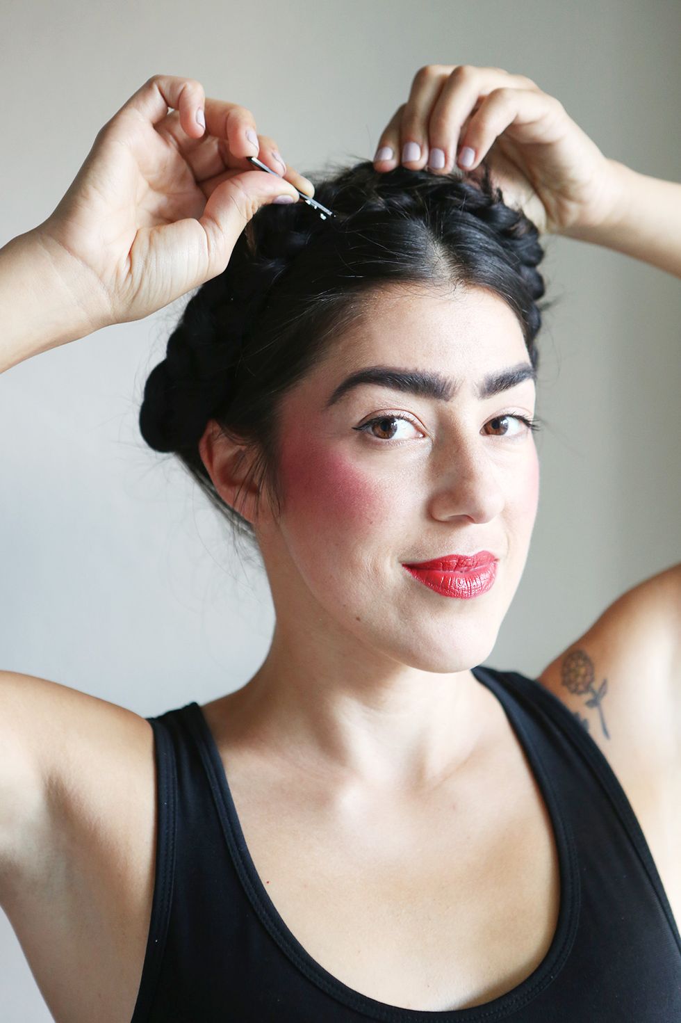 Bring both braids up and across your head, pinning them at least a finger's distance from your hairline to create a crown.